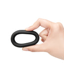 b-Vibe Snug Ring 40 mm Stretch Silicone Cock Ring Black held in a hand, showcasing its sleek design.