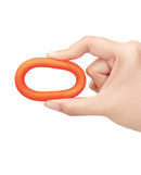 b-Vibe Snug Ring 40 mm Silicone Cock Ring Orange held in hand, showcasing its vibrant design and flexible material.