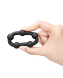 b-Vibe Snug Ring Orbit Nubby Silicone Cock Ring held in hand, showcasing textured silicone design.