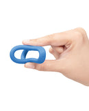 b-Vibe Snug Ring Tri-Sling Silicone Cock-and-Ball Sling held in hand, showcasing its ergonomic design.