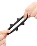 b-Vibe Flex Ring Spike Super Soft Silicone Cock Ring being stretched between two hands to showcase its flexibility.