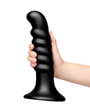 b-Vibe Krush 9.5 Inch Curved Ribbed XXL Suction Cup Dildo held in hand, showcasing its sleek design and texture.
