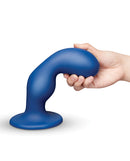 Image of b-Vibe Milk 8.5 Inch Curved XXL Anal Trainer being held, showcasing its smooth design and ergonomic shape.