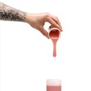 Hand pouring medium skin tone silicone from cup for Clone-A-Willy refill kit.