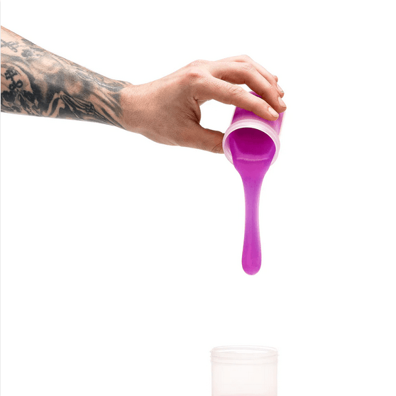 Pouring neon purple silicone from Clone-A-Willy refill pack into container