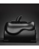 The Cowgirl Buckwild Silicone Attachment Black showcased on a sleek black surface, highlighting its dual-penetration design.