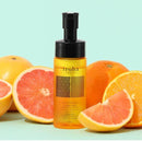 Tenga Iroha Intimate Wash Citrus 150 ml bottle surrounded by citrus fruits on a bright background.