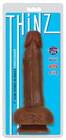 Thinz 7 inches Slim Dong with Balls Chocolate on a blue packaging background showcasing its slim design.
