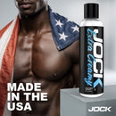 JOCK Extra Creamy Water Based Lubricant 8 Oz bottle displayed with muscular model draped in flag, made in the USA.