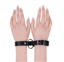 Image of Sex & Mischief Shadow Convertible Cuffs showcasing sleek black faux leather with polished silver-tone hardware.