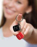 "Super Fun Key Chain Sex Dice with playful design held towards the camera"