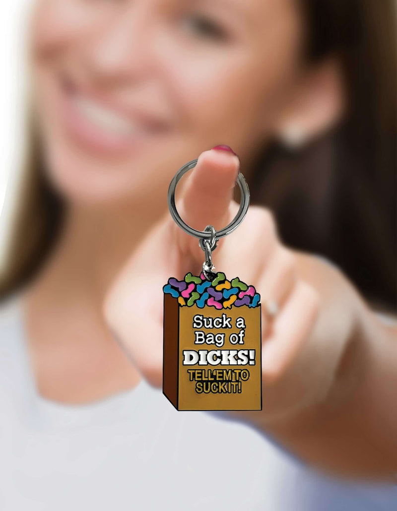 Woman holding a novelty "Suck a Bag of Dicks" keychain with colorful design, perfect for adding fun to keyrings.