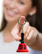 Person holding a Super Fun Key Chain Ring for Sex by Little Genie with a bell symbolizing a playful and flirty accessory.