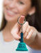 Woman holding a novelty "Ring for Anal" keychain bell with playful message.