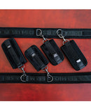Sei Mio Pretty Thighed Up Thigh Wrist and Ankle Restraint set on a red surface, showcasing its elegant design.