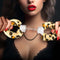Woman holding Temptasia Beginner Leopard Cuffs, stylish and comfortable bondage cuffs for BDSM play with safety features.