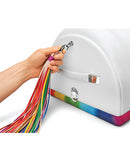 A hand holding colorful ribbons attached to The Cowgirl Unicorn Premium Sex Machine.