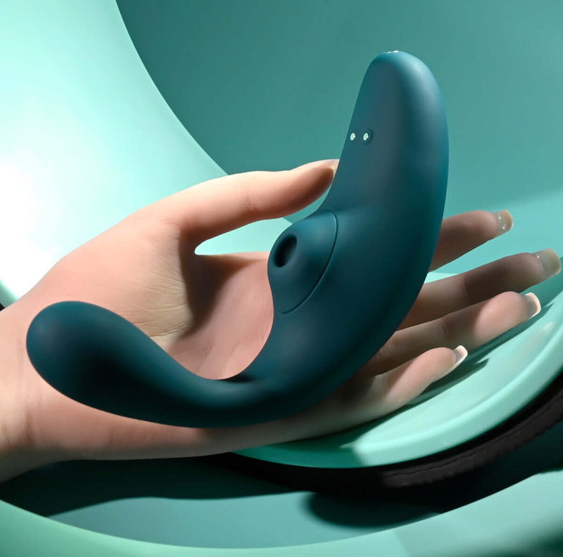 Playboy Charmer Dual Vibrator with Clitoral Suction and Flexible Shaft held in hand, showcasing its waterproof and rechargeable features.