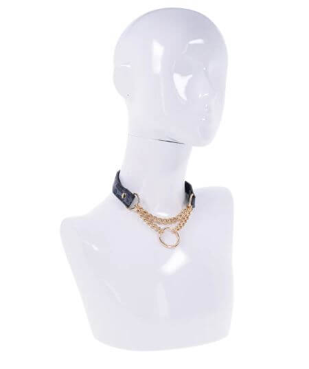 Stylish animal print faux leather day collar with gold hardware and ring displayed on a mannequin bust.