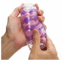 Tenga Arte Drape Stroker held in hand, showcasing its textured design and colors for a unique pleasure experience.