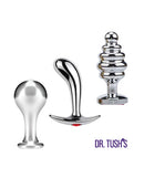 Dr Tush's Tools of Temptation Medium Anal Plug Set Metal featuring three metal plugs in various shapes.