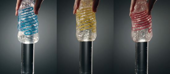 Tenga Spinner DX 01 Drops Stroker shown in blue, yellow, and red with dynamic internal orbs for stimulation.