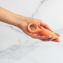 Emojibator Cheeky Vibrating Butt Plug held in hand, showcasing sleek silicone design and comfortable fit.