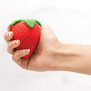 Emojibator Strawberry Suction Vibrator held in hand, showcasing its playful strawberry design.
