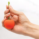 Emojibator Cherry Rechargeable Vibrator held in hand, showcasing its playful cherry design and ergonomic shape.
