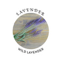 Wild lavender flowers arranged in a circular design with a wood background.