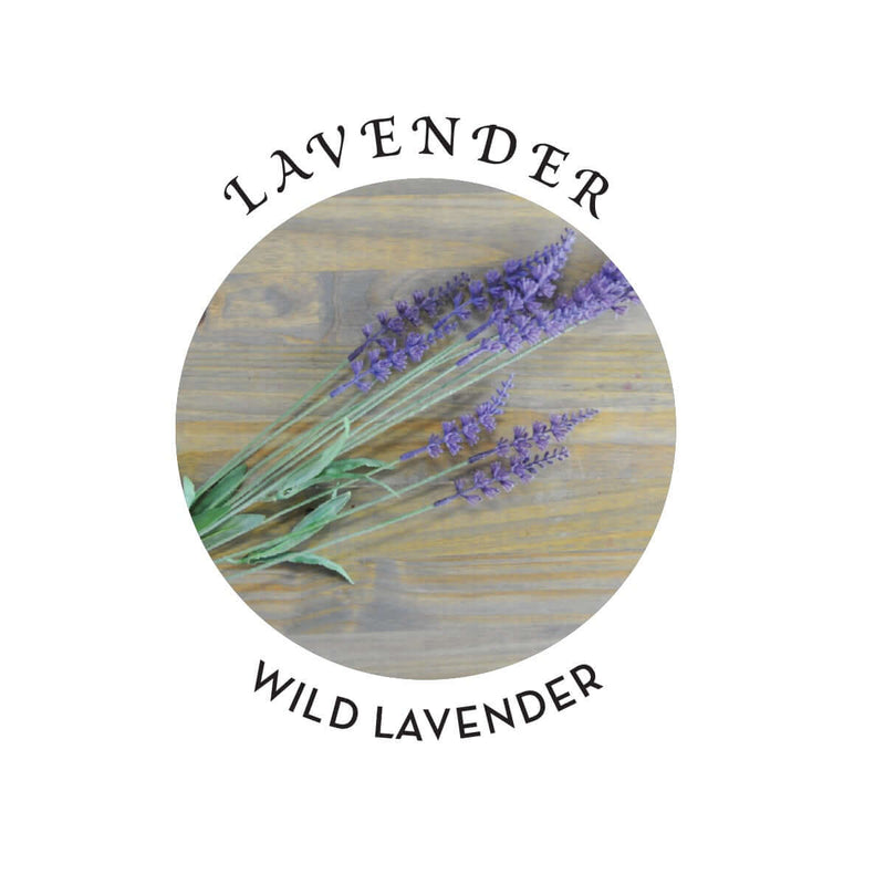 Wild lavender flowers arranged in a circular design with a wood background.
