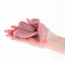 G-Spot vibrator in hand, featuring remote control for clitoral stimulation - pink silicone design.