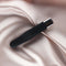 Edonista Layla Black Silicone Twist Bullet Vibrator on soft satin fabric, showcasing its sleek, flexible design.