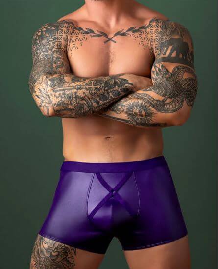 Male Power Eggplant Crossover Short Plum L shown on a muscular man with tattoos, featuring a sleek purple design.