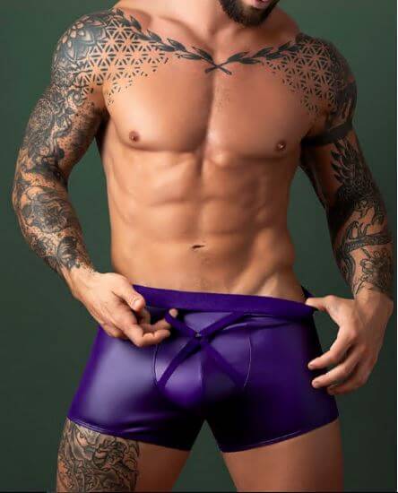 Male Power Eggplant Crossover Short Plum S M showcased by a muscular model wearing purple wet-look underwear.