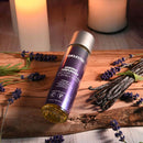 Anoint Perfumery Massage Oil Lavender Flower & Vanilla Bean in a serene setting with lavender and candles.
