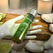 Anoint Perfumery Lime Infused Coconut Massage Oil 4oz in a decorative setting with fresh lime and coconut.