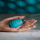Hand holding Evolved Oval Office remote control vibrating egg in blue.