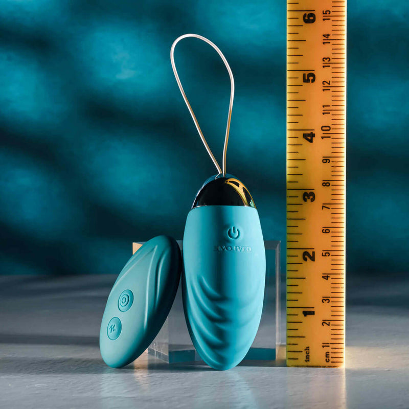 Evolved Oval Office remote-control vibrating egg with measuring ruler for size comparison