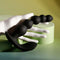 Black silicone vibrating anal beads held in a hand, featuring graduated sizes and a curved design for intimate stimulation.