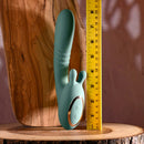 Poseable thrusting vibrator with rotating prongs and ruler for size comparison on wooden surface.