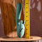 Poseable thrusting vibrator with rotating prongs and ruler for size comparison on wooden surface.