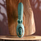Poseable thrusting vibrator with rotating prongs on a wooden surface, perfect for intense stimulation and bending flexibility.
