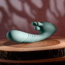 Poseable thrusting vibrator with rotating prongs on wooden surface for intense pleasure and precise stimulation.