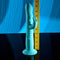Bunny Hop Rechargeable Silicone Throbbing Rabbit Vibrator in blue, showing its size next to a measuring tape on a reflective surface.