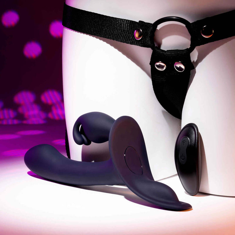 Giving Vibes Rechargeable Silicone Triple Vibrator in purple with adjustable harness for intense pleasure.