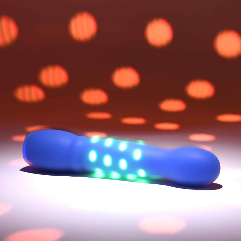 Disco Diva Rechargeable Silicone Vibrator Blue with pulsing green LED lights on a colorful background.