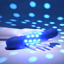 Disco Diva Rechargeable Silicone Vibrator Blue with LED lights on hand against a blue background, showcasing its vivid effects.