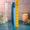 Queen of All Trades rechargeable silicone dual vibrator in blue next to a measuring tool for size comparison.