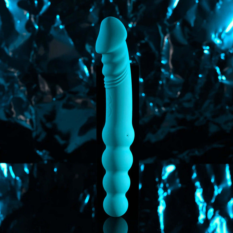 Blue rechargeable silicone dual end vibrator with textured shaft and beaded side, water submersible design.